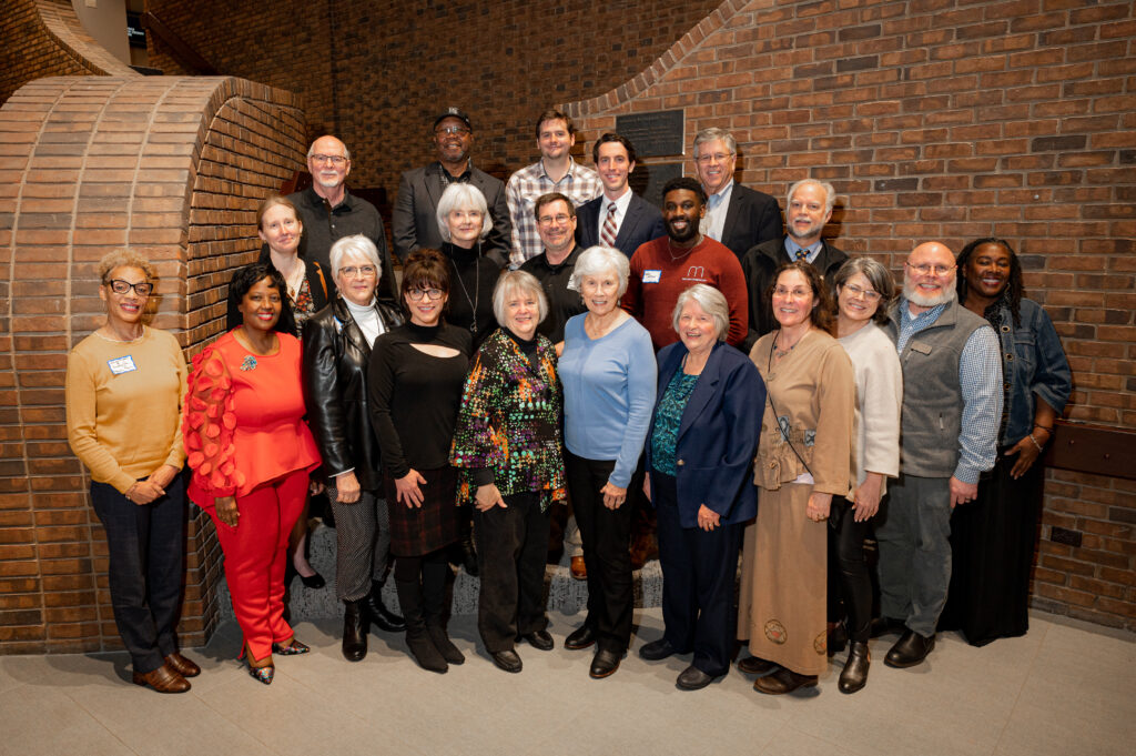 group of grant recipients standing together for a photo on a staircase