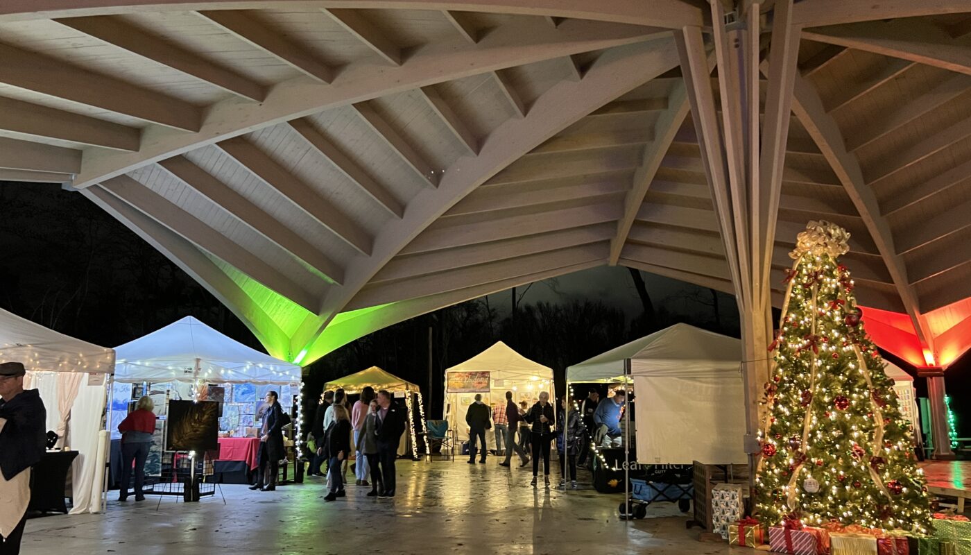 Art booths under an architectural done with a Christmas tree in the center