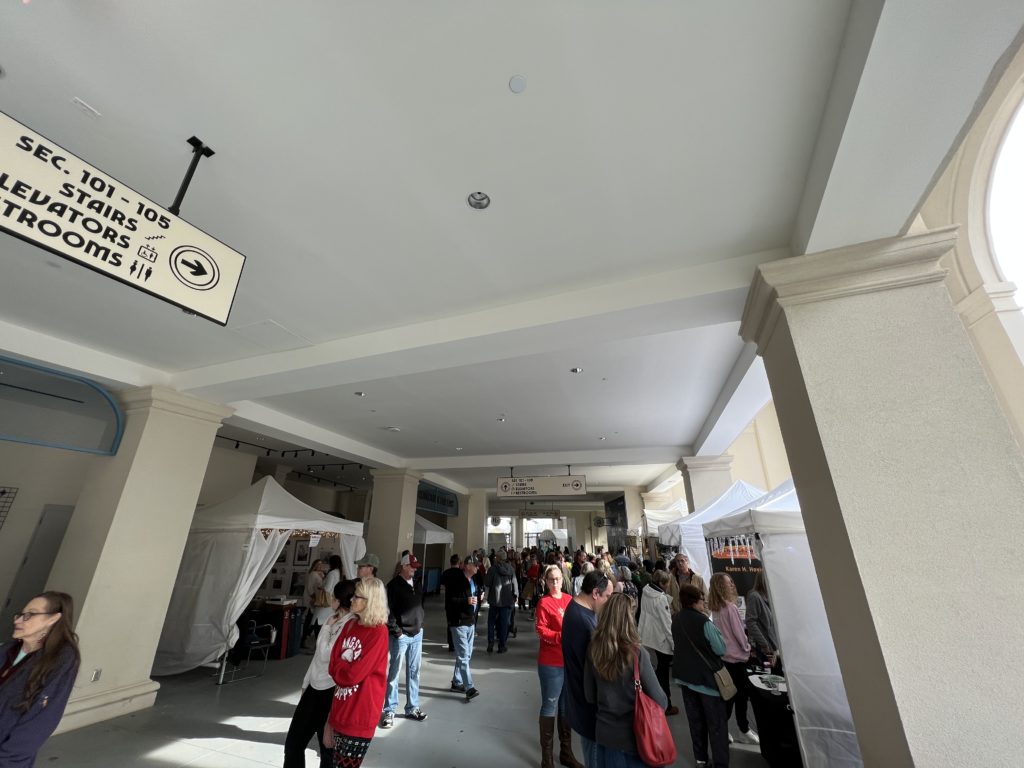 View down a concourse with art vendors and shoppers