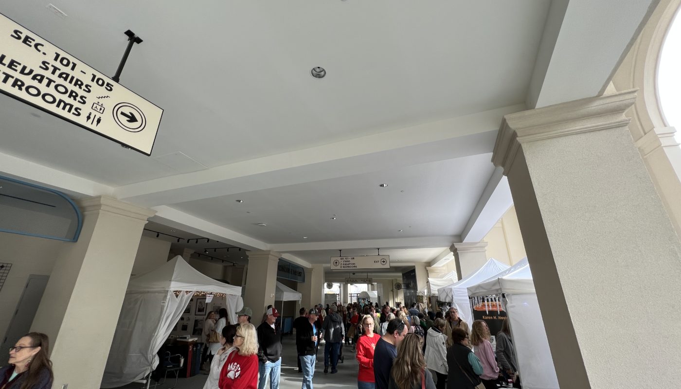 View down a concourse with art vendors and shoppers