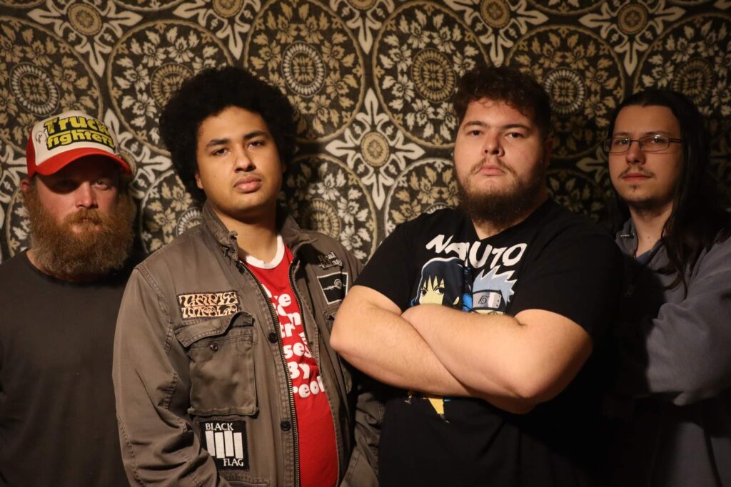 Free Candy band posing in front of a wallpapered wall
