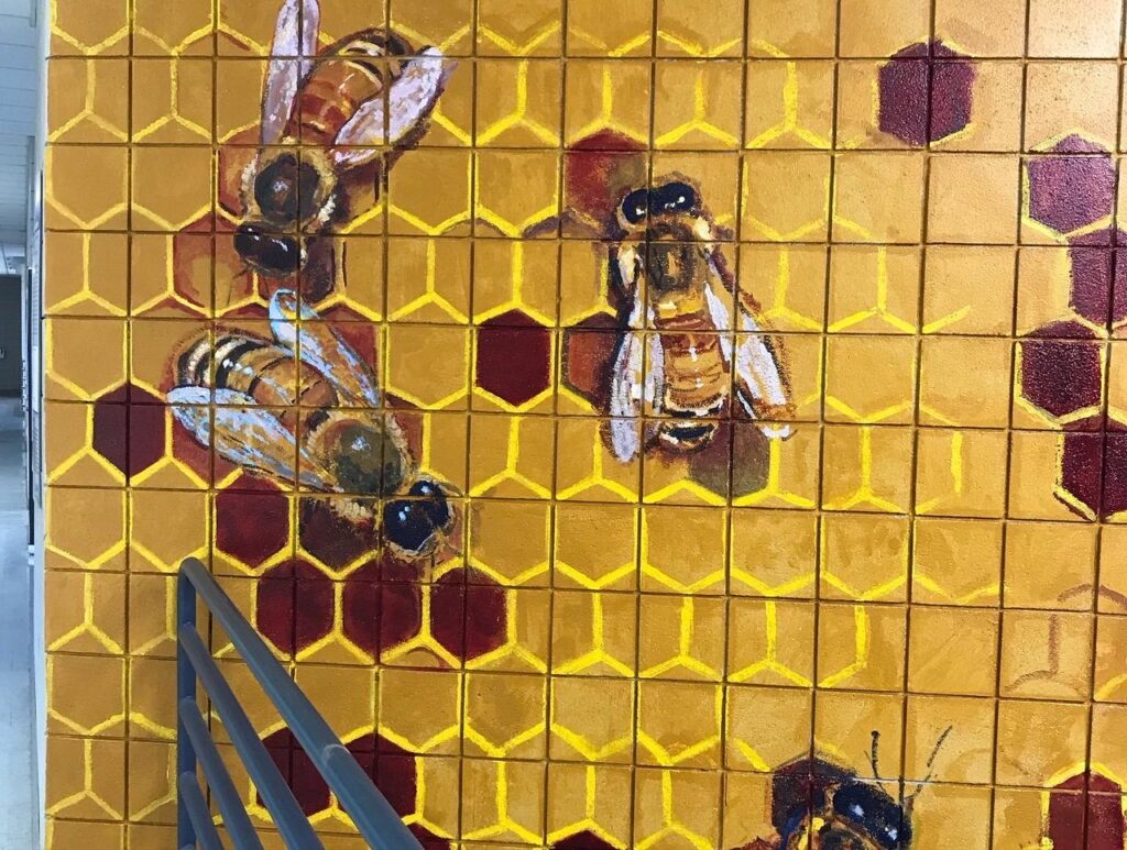 A painting of bees on honeycomb.