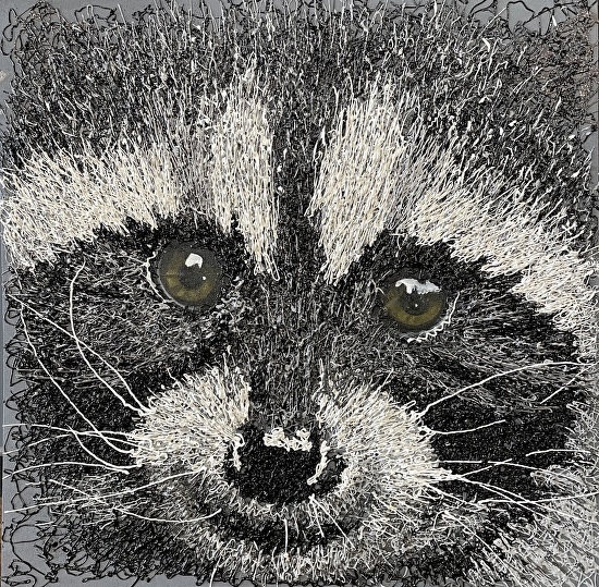 Squeeze bottle painting of a raccoon's face.