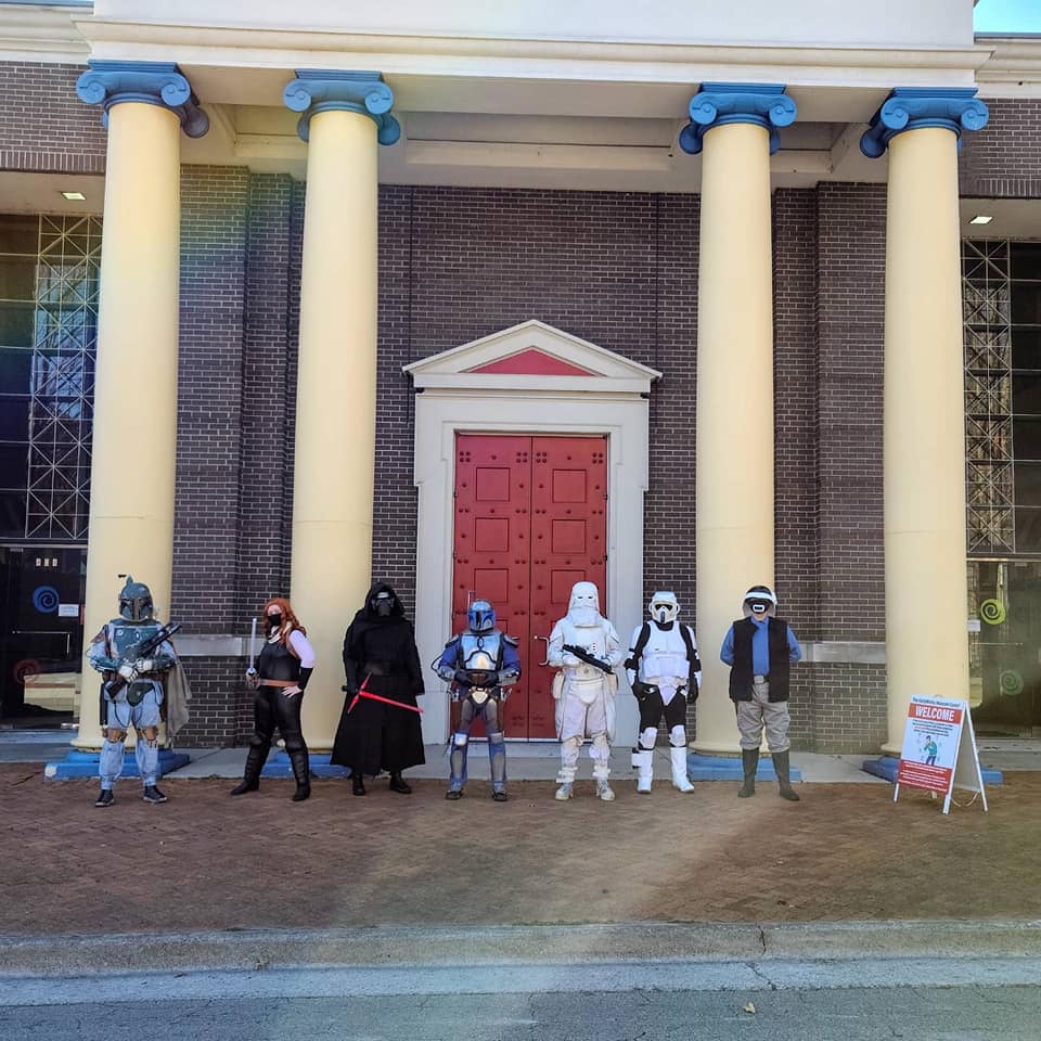 Big red door and columns with Star Wars cosplayers standing in front