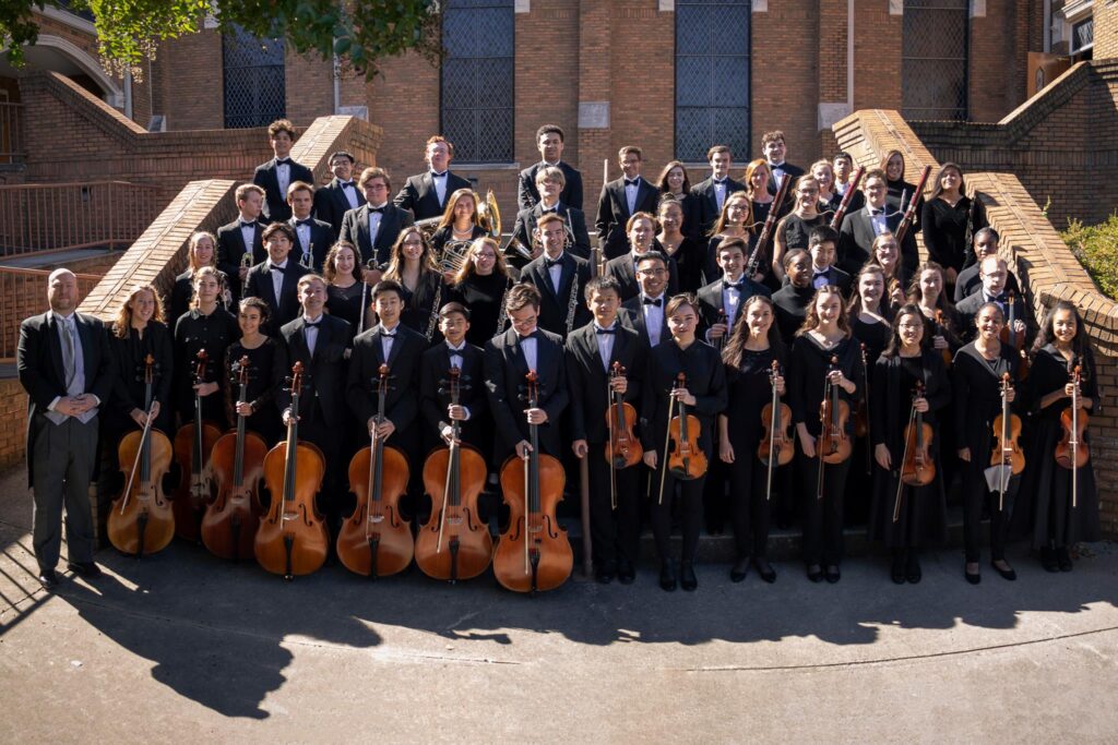 Huntsville Youth Orchestra musicians posing with their instruments.