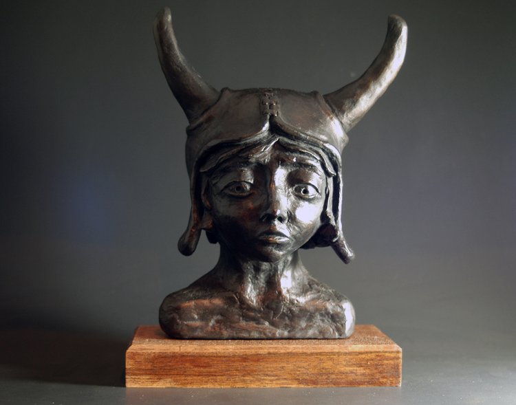 A sculpture bust of a whimsical viking girl.