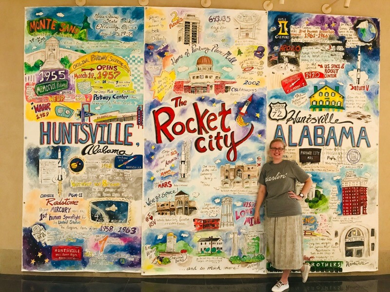 The Art Lady in front of one of her collage-style murals.