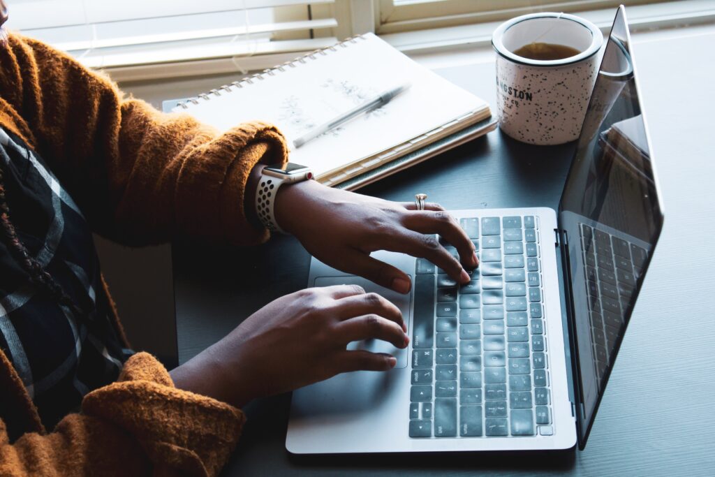 Hands typing up a proposal.