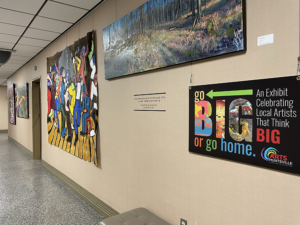 Hallway view of the 'Go Big or Go Home' art exhibit at the Arts Huntsville gallery.