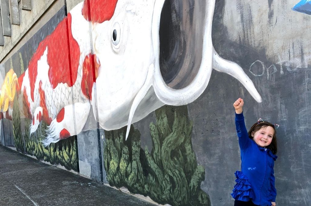 Child with Dustin Timbrook's Mural, Photo by @RocketCityDietician